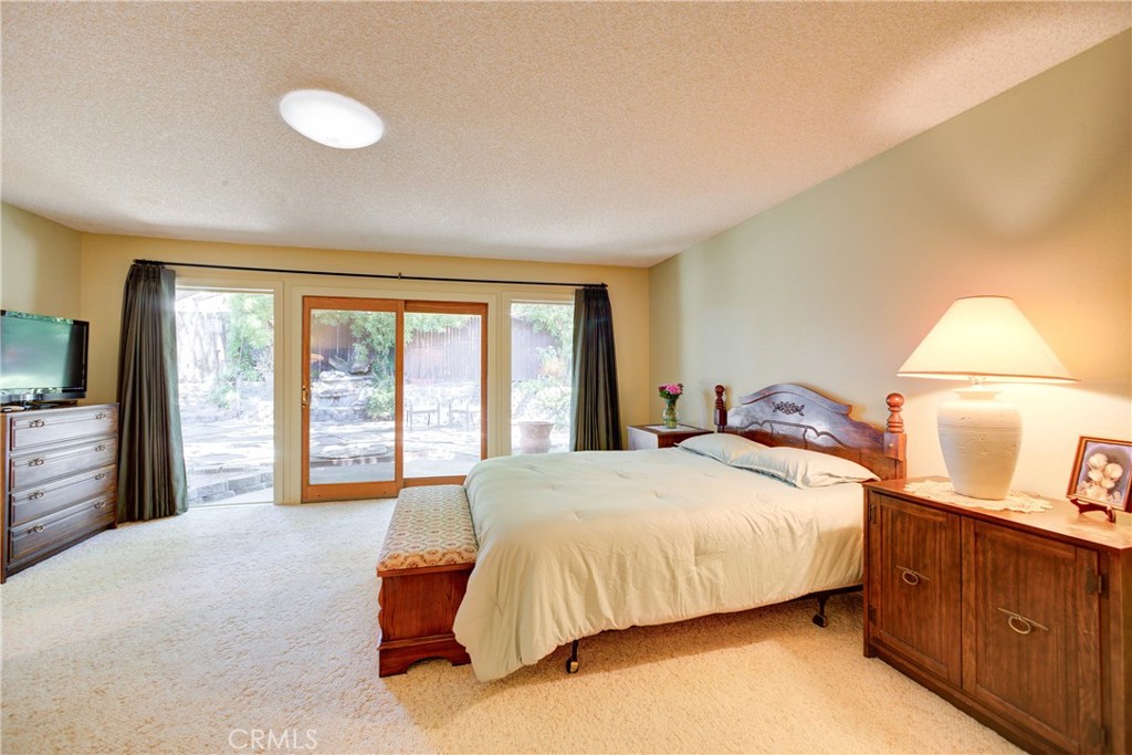 4185 Vanguard Drive Lompoc, CA 93436 - Photo 22 of 44 a bedroom with a bed and a dresser with mirror