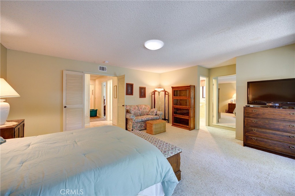 4185 Vanguard Drive Lompoc, CA 93436 - Photo 24 of 44 a spacious bedroom with a bed and a flat screen television