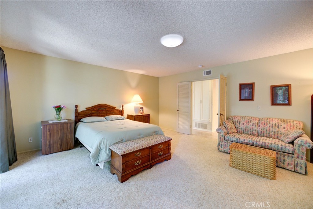 4185 Vanguard Drive Lompoc, CA 93436 - Photo 25 of 44 a spacious bedroom with a bed and a couch
