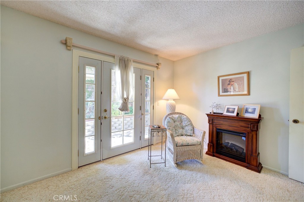 4185 Vanguard Drive Lompoc, CA 93436 - Photo 30 of 44 a living room with furniture a large window and a fireplace