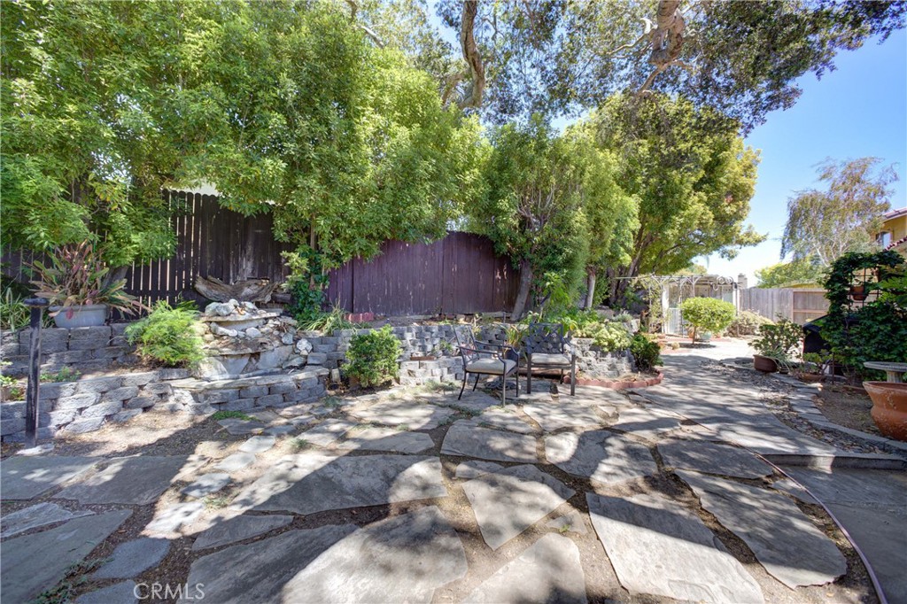 4185 Vanguard Drive Lompoc, CA 93436 - Photo 39 of 44 a view of backyard with a table and chairs and potted plants