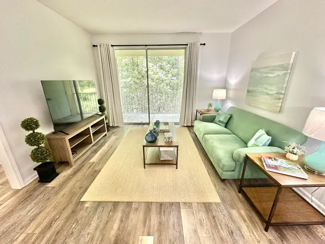 a living room with furniture and a large window