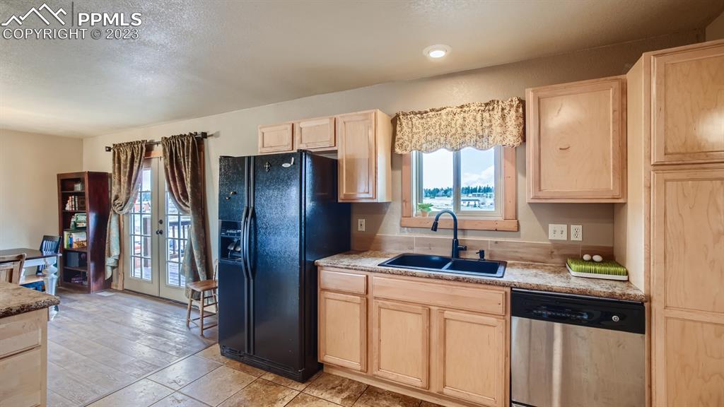29 Ridge Point Circle Divide, CO 80814 - Photo 19 of 50 a kitchen with stainless steel appliances granite countertop a refrigerator and a sink