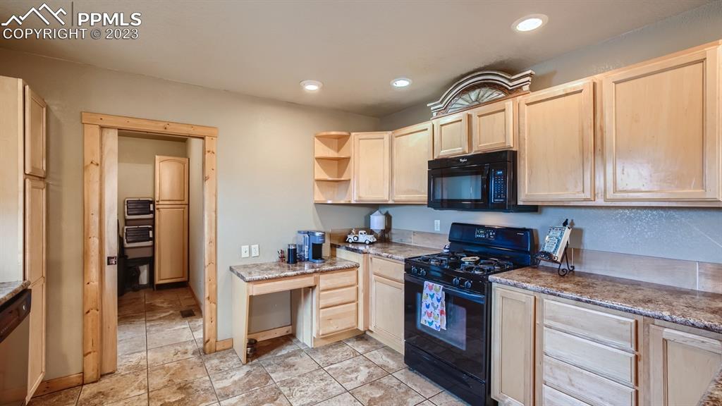 29 Ridge Point Circle Divide, CO 80814 - Photo 21 of 50 a kitchen with stainless steel appliances granite countertop a stove a sink and a microwave