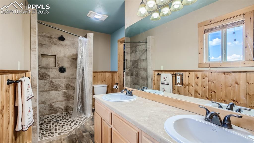 29 Ridge Point Circle Divide, CO 80814 - Photo 29 of 50 a bathroom with a granite countertop sink a mirror and shower