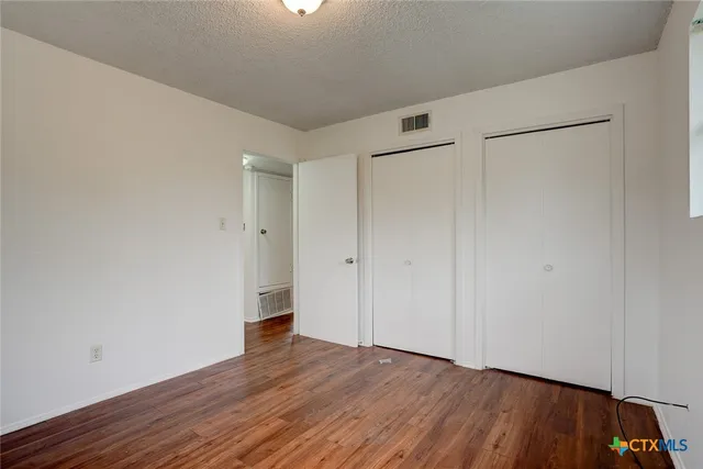 a view of an empty room and wooden floor
