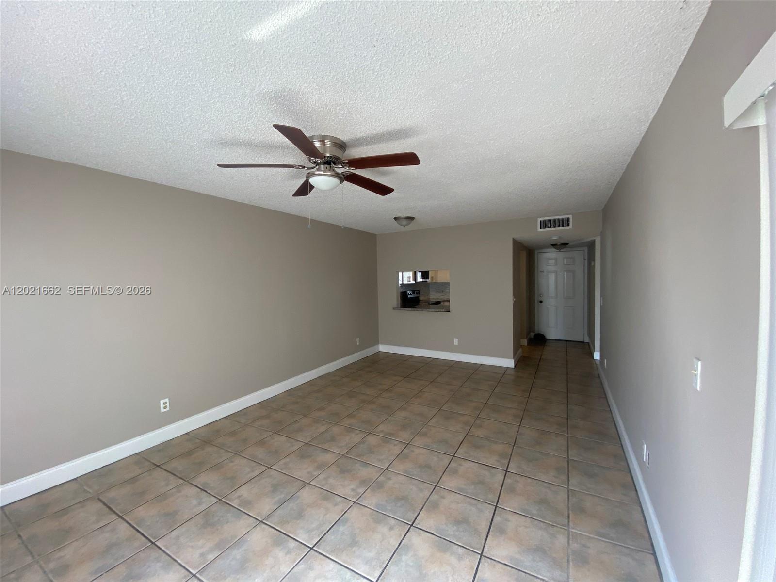 3263 Kirk Road, Unit 2 Lake Worth, FL 33461 - Photo 2 of 14 a view of a livingroom with a ceiling fan & wooden floor