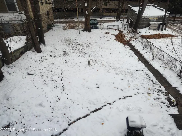 a view of a backyard of the house