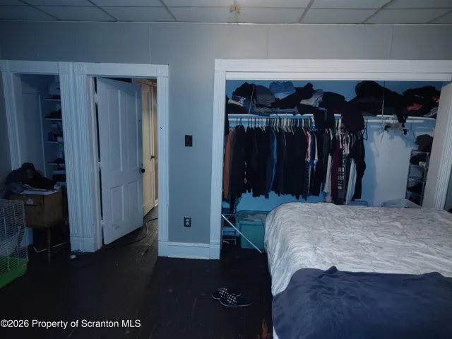 a bedroom with a bed and a closet