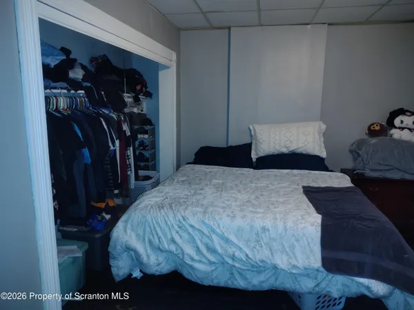 a bedroom with a bed and a mirror