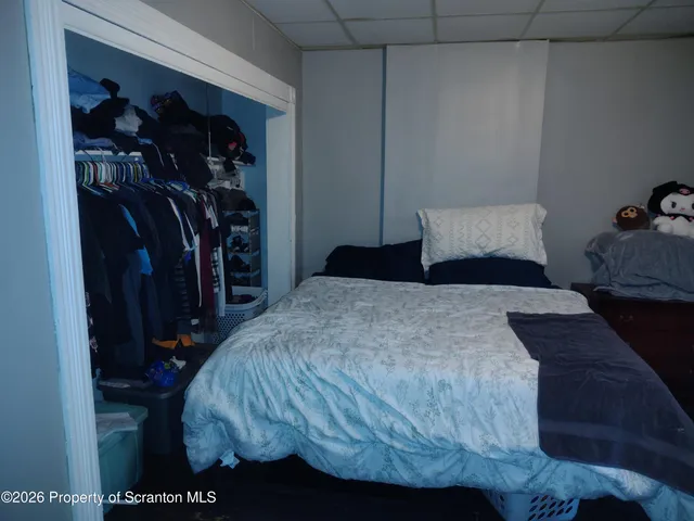 a bedroom with a bed and a mirror