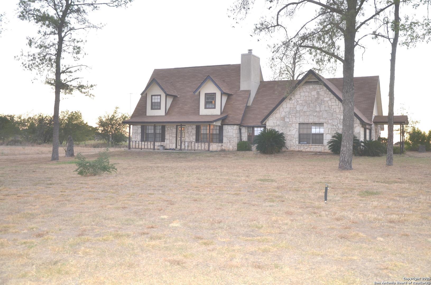 115 B Littleton Drive Devine, TX 78016 - Photo 1 of 27 a front view of a house with a yard