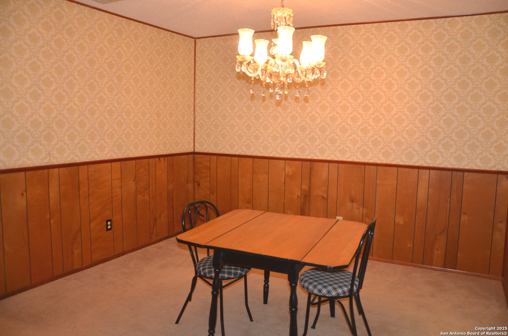115 B Littleton Drive Devine, TX 78016 - Photo 11 of 27 a view of a dining room with furniture and chandelier