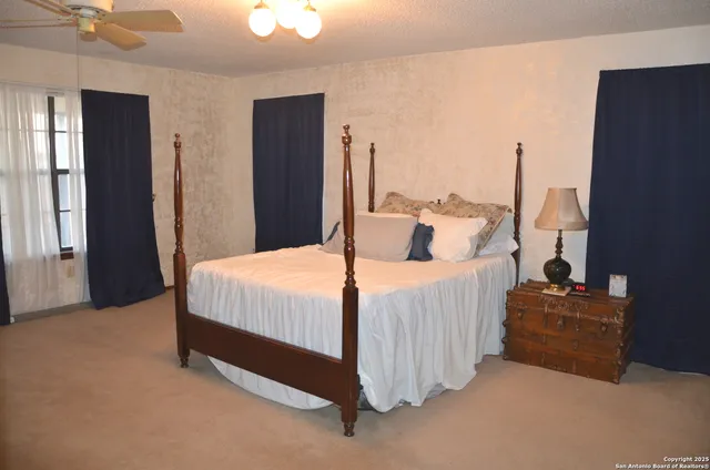 a bed sitting in a bedroom next to a window