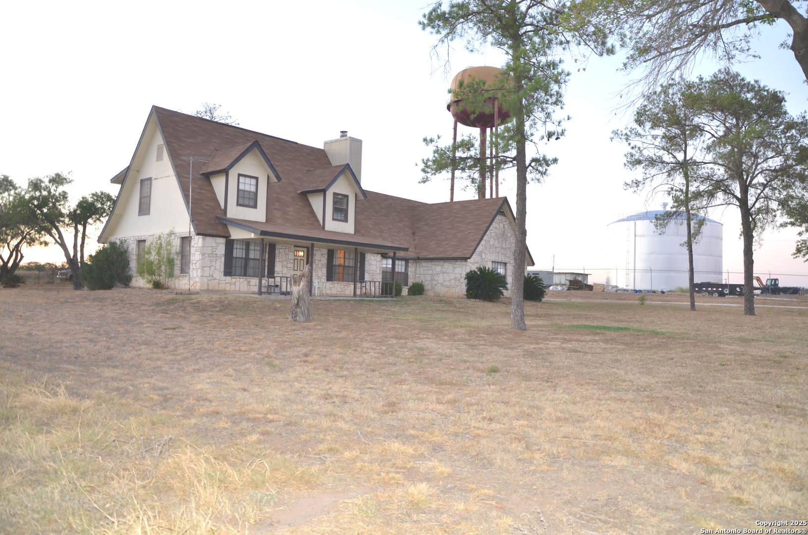 115 B Littleton Drive Devine, TX 78016 - Photo 15 of 27 a view of a house with a yard