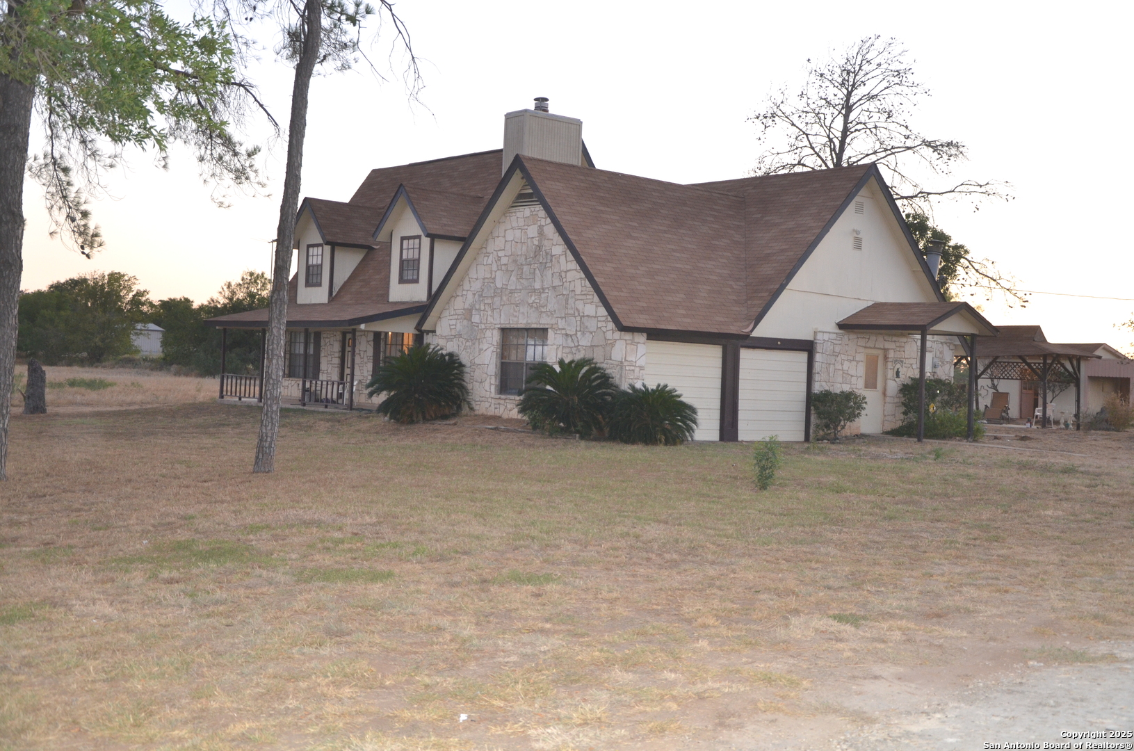 115 B Littleton Drive Devine, TX 78016 - Photo 16 of 27 a front view of a house with a yard and garage