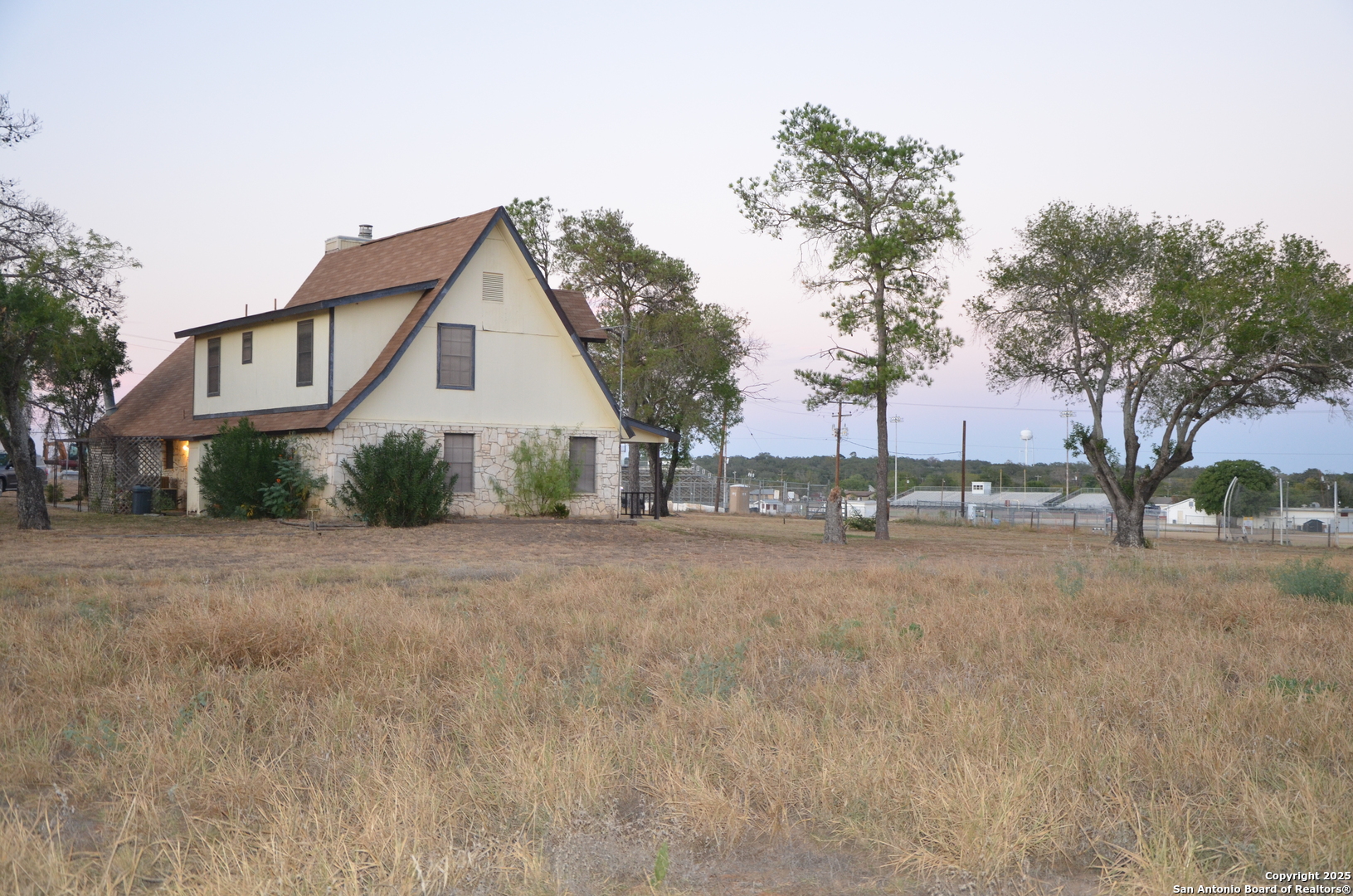 115 B Littleton Drive Devine, TX 78016 - Photo 17 of 27 a view of a house with a street