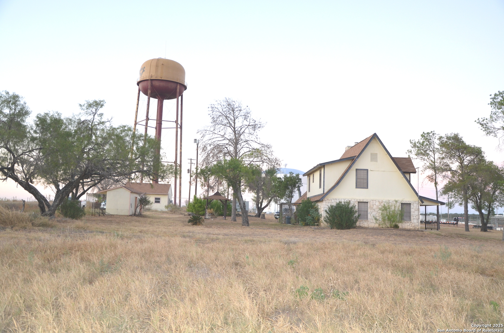 115 B Littleton Drive Devine, TX 78016 - Photo 18 of 27 a front view of a house with a yard and garage