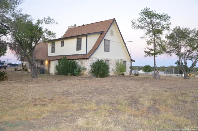 a view of a house with a yard and plants