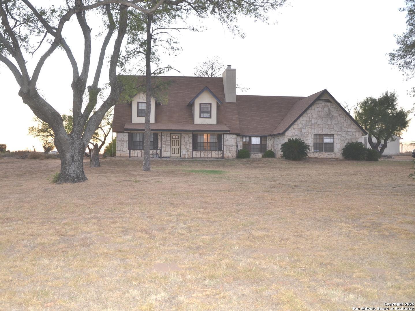 115 B Littleton Drive Devine, TX 78016 - Photo 2 of 27 a view of a house with a snow in the yard