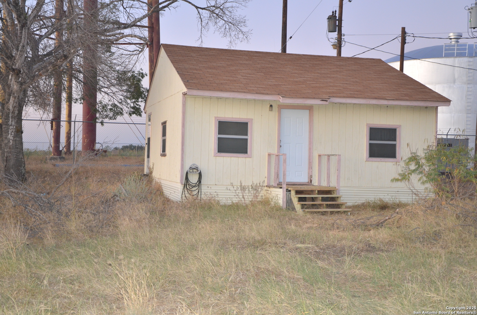115 B Littleton Drive Devine, TX 78016 - Photo 24 of 27 a backyard of a house with table and chairs