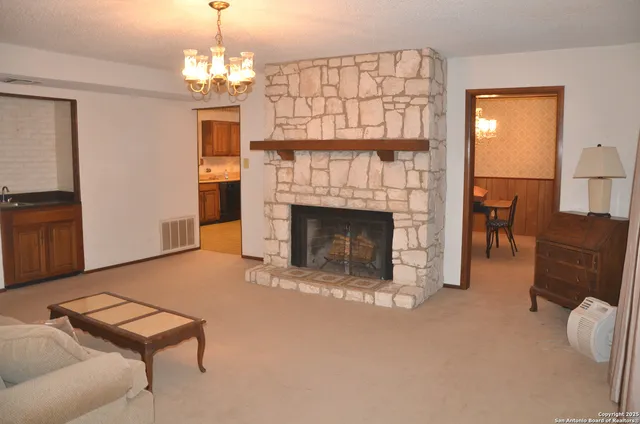a living room with furniture and a fireplace