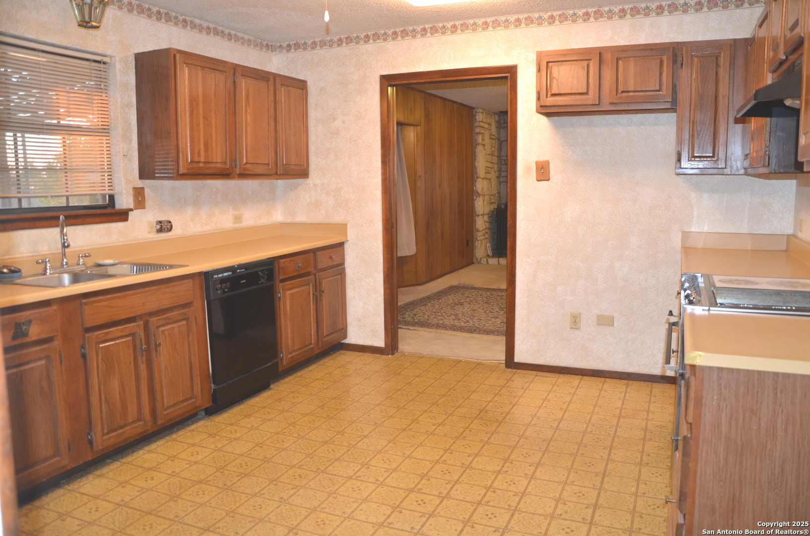 115 B Littleton Drive Devine, TX 78016 - Photo 7 of 27 a kitchen with stainless steel appliances granite countertop a sink stove and cabinets