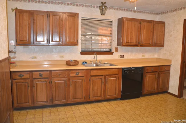 a kitchen with stainless steel appliances granite countertop a sink dishwasher stove and cabinets
