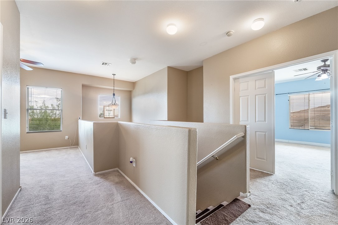 224 Positive Point Street Henderson, NV 89012 - Photo 19 of 44 Plush carpeting anchors this versatile upstairs landing opening to an adjacent bedroom.