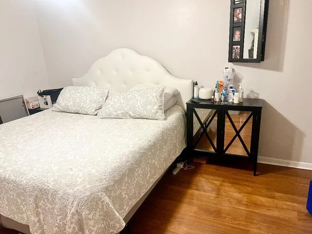 a bed sitting in a bedroom next to a window