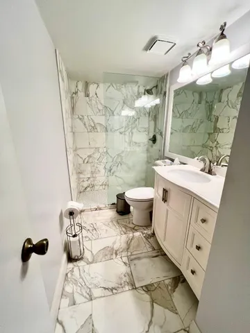 a bathroom with a sink toilet and shower