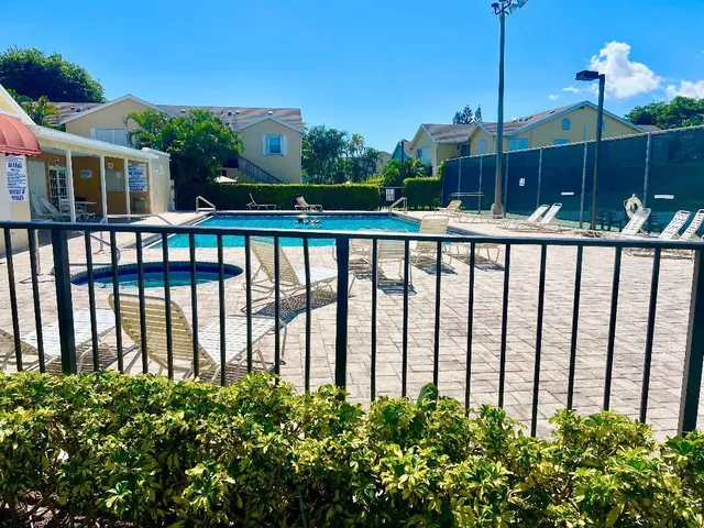 a view of a porch with a floor to ceiling window and wooden fence