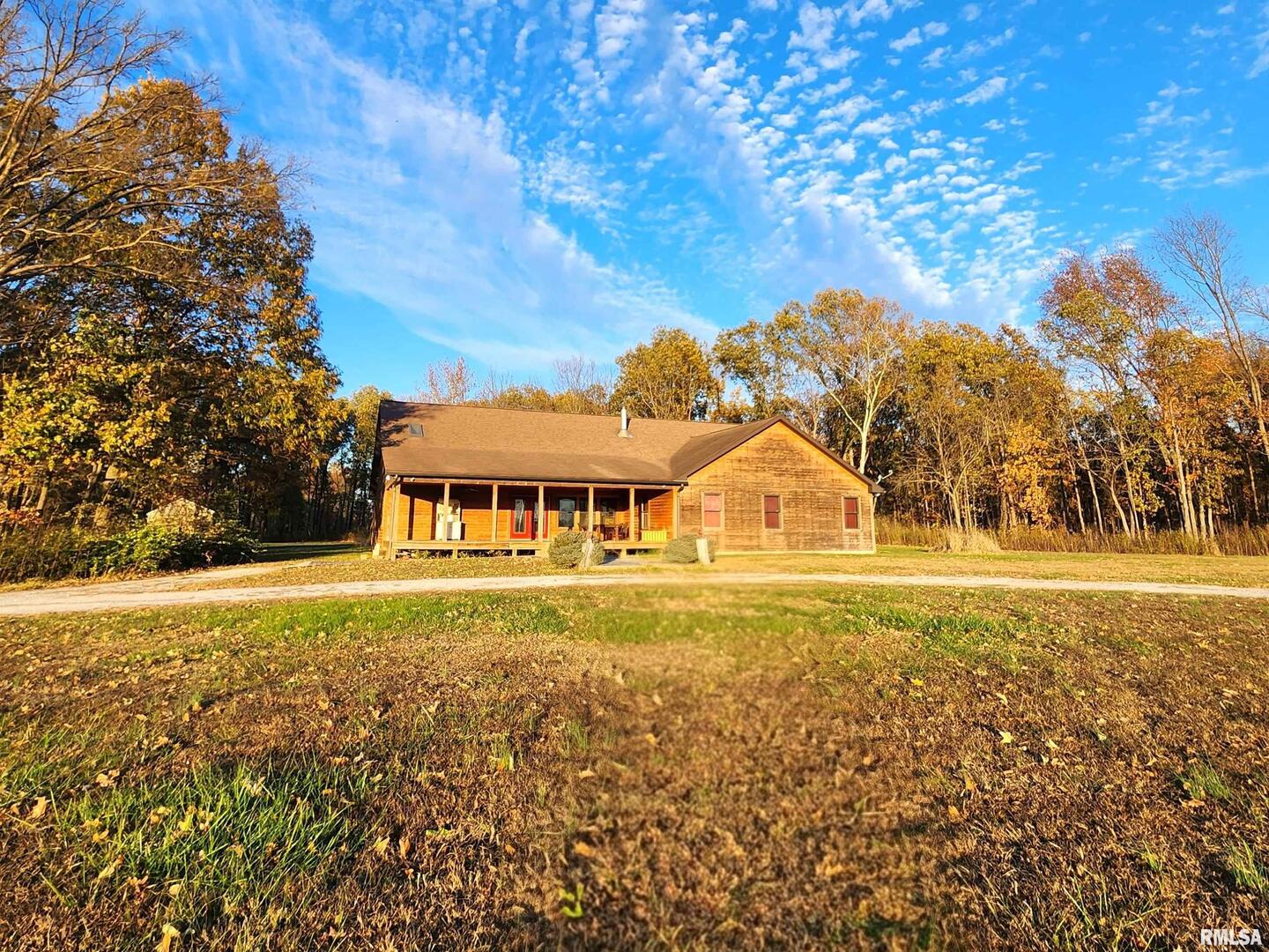 a front view of house with yard green space and outdoor seating