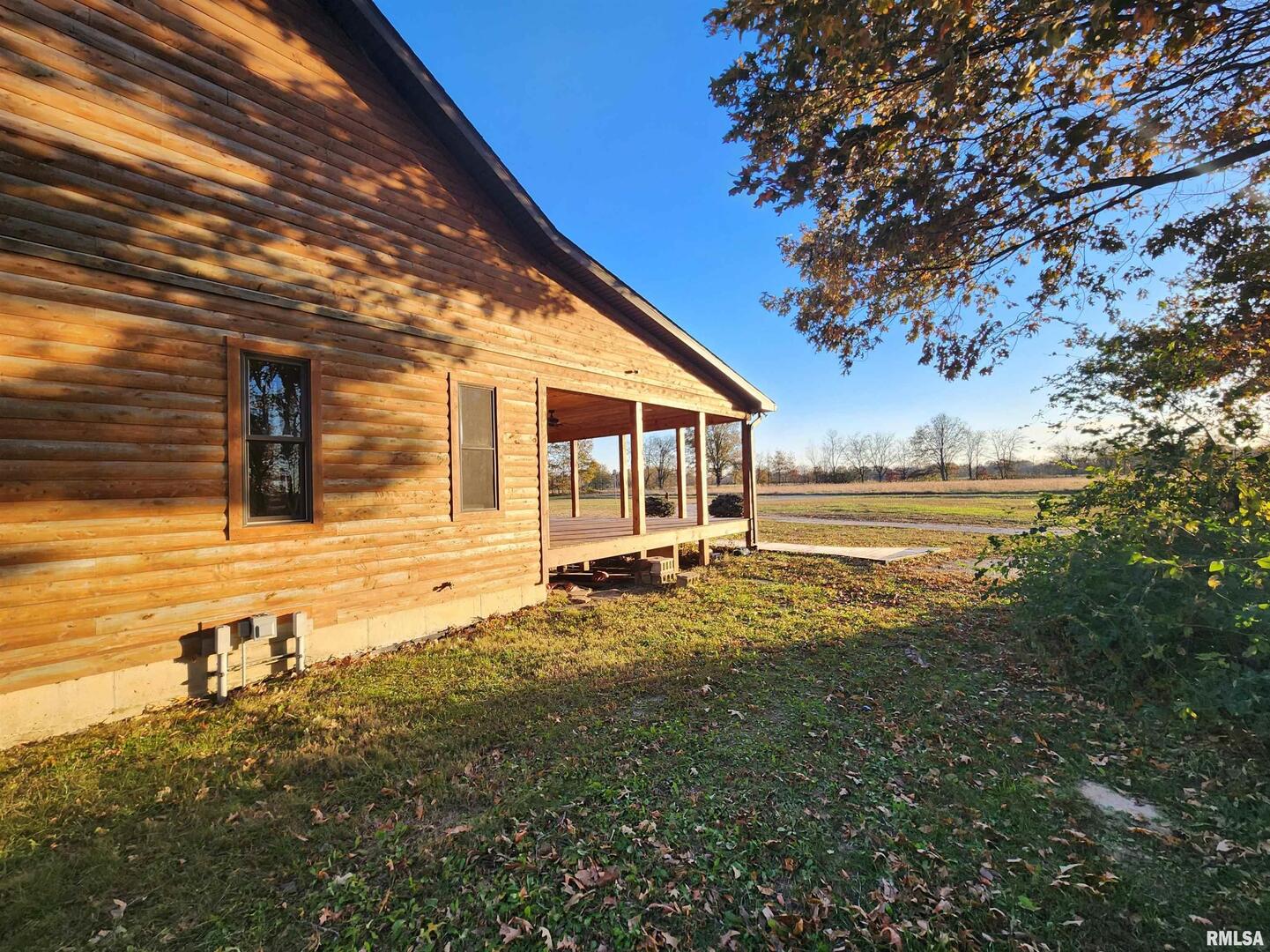 253 Ween Road De Soto, IL 62924 - Photo 36 of 56 a backyard of a house with table and chairs under an umbrella
