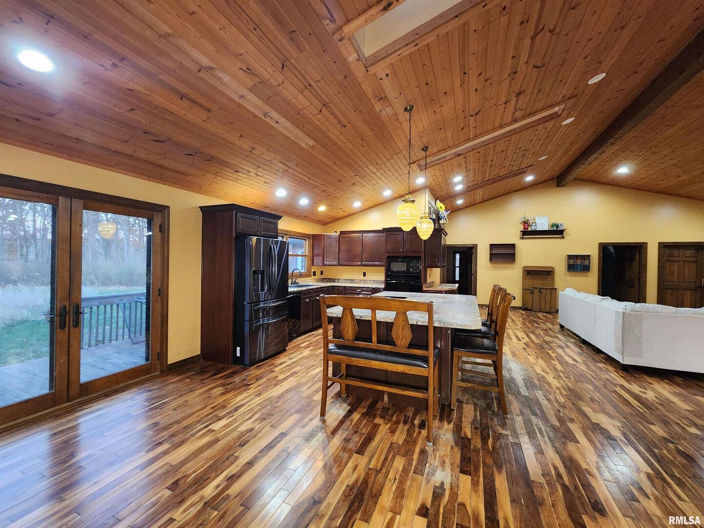 253 Ween Road De Soto, IL 62924 - Photo 5 of 56 a living room with stainless steel appliances kitchen island granite countertop furniture and a wooden floor