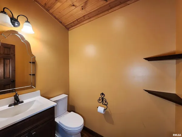 a bathroom with a sink mirror vanity and toilet