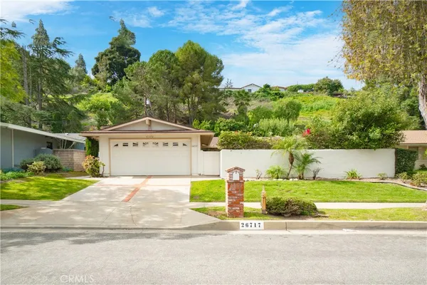 a view of a house with a yard and fence