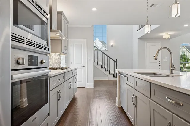 a kitchen with cabinets a sink and appliances