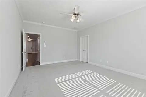 a view of a room with a ceiling fan and hardwood floor