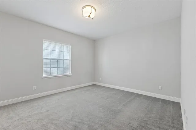 an empty room with a empty space and windows