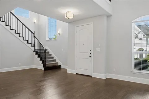 a view of entryway and hall with wooden floor