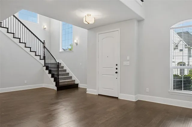 a view of entryway and hall with wooden floor