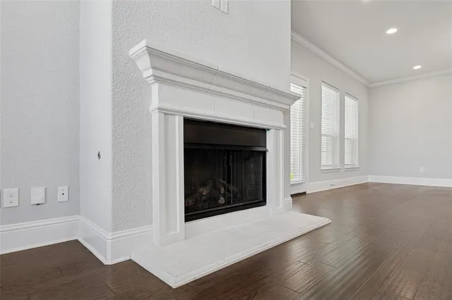 a living room with a fireplace and wooden floor