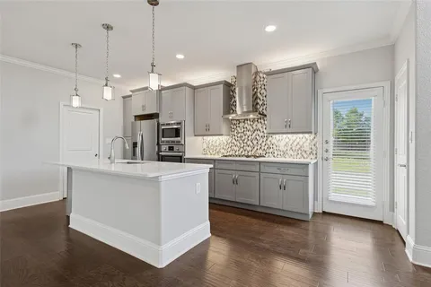 a kitchen with white cabinets and sink