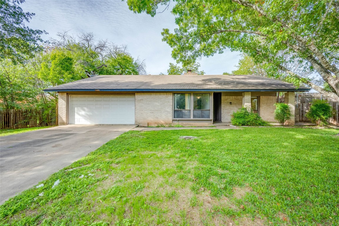 1402 Meadgreen Circle Austin, TX 78758 - Photo 2 of 35 Ranch-style house with brick siding, driveway, an attached garage, a chimney, and a shingled roof