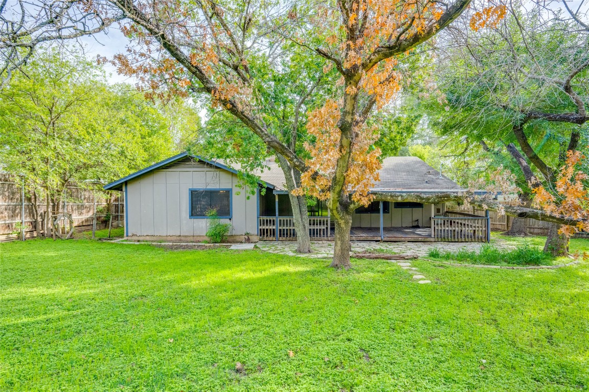 1402 Meadgreen Circle Austin, TX 78758 - Photo 26 of 35 Back of house with a fenced backyard, board and batten siding, and a wooden deck