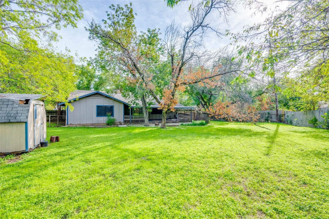1402 Meadgreen Circle Austin, TX 78758 - Photo 27 of 35 Fenced backyard featuring a shed