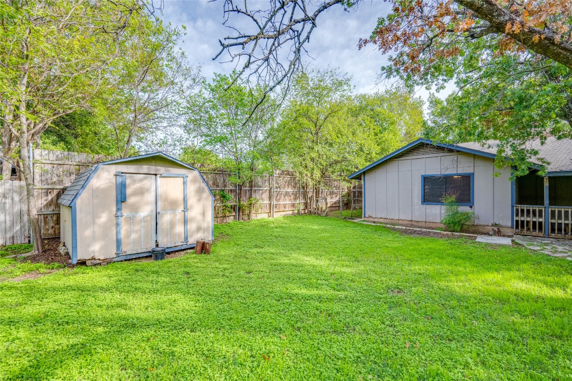 1402 Meadgreen Circle Austin, TX 78758 - Photo 28 of 35 Fenced backyard featuring a storage unit