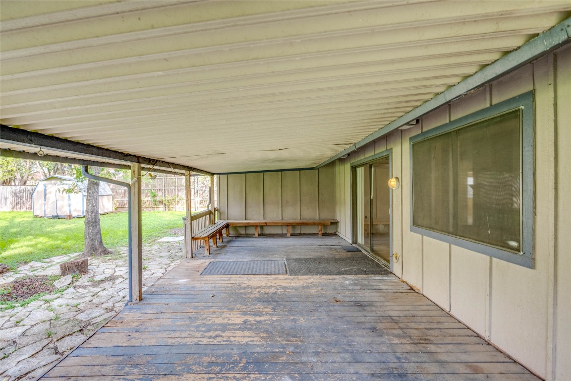 1402 Meadgreen Circle Austin, TX 78758 - Photo 35 of 35 View of patio featuring a deck and a storage unit