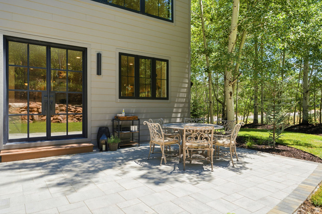 3027 Homestead Road Park City, UT 84098 - Photo 61 of 62 Expansive paver patio with a stone-finish border, directly accessible from the interior via black-framed French doors